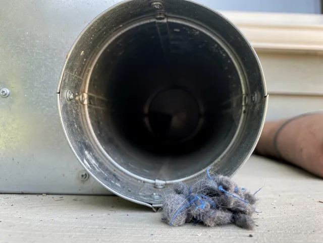 Town 'n' Country Dryer Vent Cleaning technician using specialized equipment to clear severe dryer vent blockage in Town 'n' Country